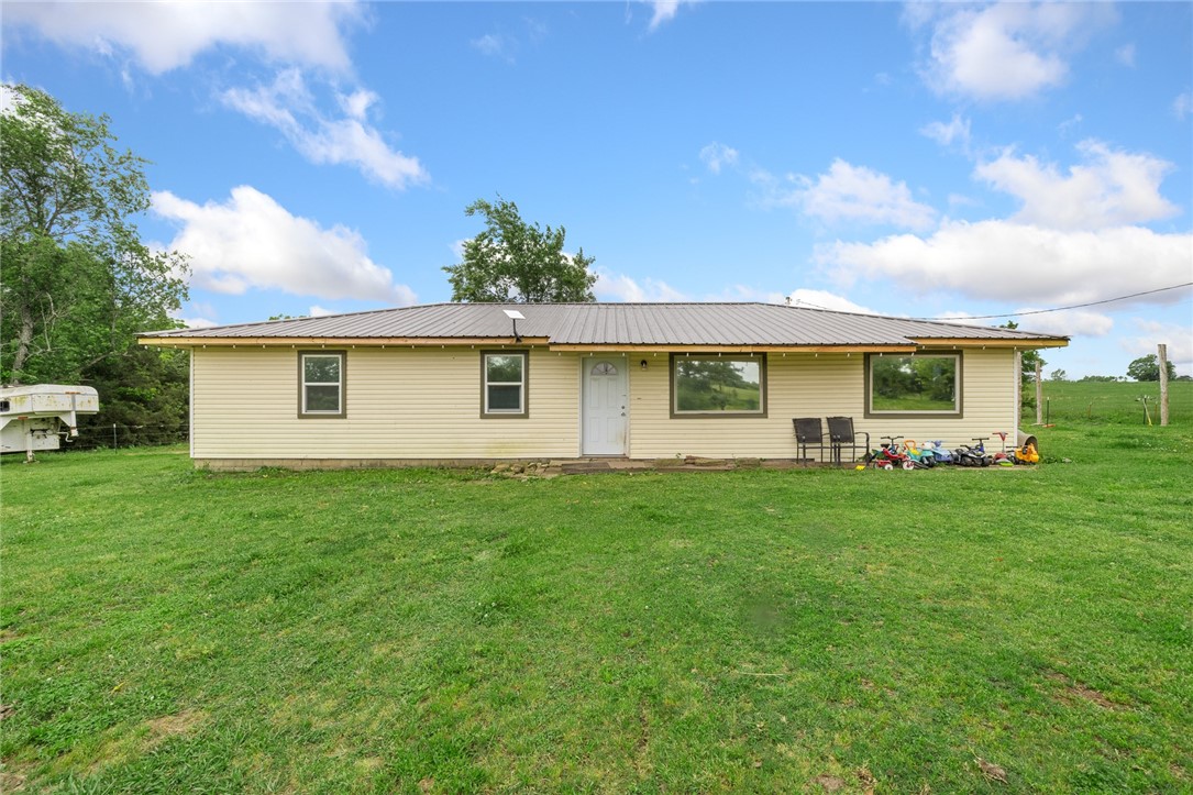 Great investment opportunity in this 3BR 1 BA house that sits on 1.5 acres. Kitchen has been beautifully updated with butcher block countertops and new stainless appliances. New LVL flooring throughout and huge storage room that could be finished out to new master suit. Property is fully fenced with gated entrance and cross fenced with pasture in the back. Plenty of room to finish out a small barn for your animals. New well pump and pressure tank in 2021, Septic pumped and new lateral lines installed 2023, Updated HVAC in 2021, and new metal roof in 2018. Home is being sold As-Is. Round Pen does not convey with house.