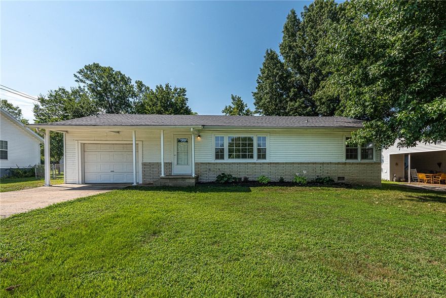 Welcome Home to South Fayetteville! This 3-bedroom home offers convenience just minutes from I-49, less than 3 miles to Downtown Fayetteville and Kessler Mountain Park! Inside, you’ll find a spacious living room with wood floors, an L-shaped eat-in kitchen with a stainless steel gas range, tiled backsplash, plenty of cabinet space, and refrigerator included. All three bedrooms feature wood flooring, and the bathroom has been updated. Off the garage, enjoy a spacious flex space with laundry area—washer and dryer included—that can double as a home office or hobby room, with plenty of opportunity to add your own storage solutions. Outside enjoy the patio overlooking the oversized, fenced backyard—perfect for pets, play, or entertaining. Don’t miss your chance to see this home, schedule a showing today! *Property is in the flood plain.