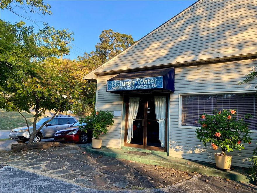 Excellent downtown area property that historically has had 'wellness' related businesses.  A rare offering only 3 blocks from the square in Fayetteville. The building currently houses various therapists (all leases have expired).  With established and matured neighborhood, this building would work well for a day spa, office building, sales offices, neighborhood convenience store, bicycle shop, medical or dental office, animal clinic or office rentals.  The common areas include a large entry, reception room, plus a very large center space where a kitchenette occupies one wall.  Two common half baths are accessible to all, and a 3rd half bath is within one office space.  A basement below most of the space can be used for storage and provides good access for adding or reworking plumbing, electrical, and other systems. The locals know this building as Nature's Water Wellness Center. Owners enjoyed many years using it as a water filtration business location.   Latest County Valuation is $870K.  Sold "AS IS"
