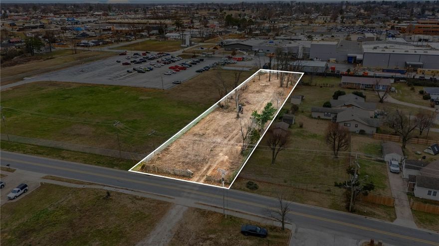Outstanding development opportunity in the heart of Rogers—prime location at 1128 W Persimmons St with high visibility and strong future potential for commercial or mixed-use redevelopment (buyer to verify zoning, permitted uses, and municipal approvals). Situated on approximately 0.75 acres, this level parcel provides a flexible footprint suited for office, retail, service-oriented, or mixed-use projects in a vibrant and growing Northwest Arkansas market. All major utilities, including public water, sewer, electricity, and natural gas, are available in close proximity, simplifying connections and reducing development costs. Typical city utility easements and right-of-way dedications will apply as shown on recorded plats; these public and franchise utility easements grant access and maintenance rights to the City of Rogers and utility providers, and may restrict building placement within easement areas (buyer to verify