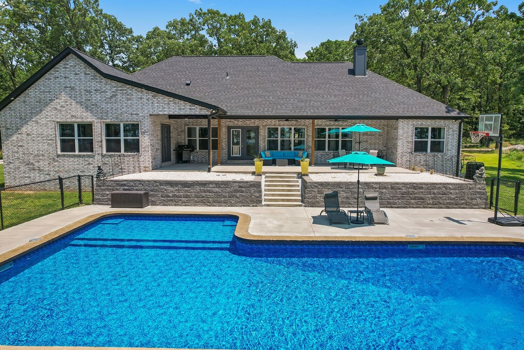 Gorgeous split floorplan home with beautiful views and a heated inground pool at the foot of Kessler Mountain! A large open living area looks out on views of not just the pool, but also an elevated view of the city of Farmington. This home features a 3 car attached garage, kitchen pantry, spacious laundry room, and a half bathroom convenient for guests to change into their swimming clothes. The sizeable heated pool has an extended shallow wading end to facilitate chair lounging or a fun area for little swimmers in addition to a deep end and diving board. A 7.37 acre lot provides ample room to run around, spread out while relaxing, or build a shop out back. The master bedroom features a soaking tub, spacious walk-in shower, and a huge master closet. Spare bedrooms are large with a Jack-and-Jill bathroom. Home is currently a successful vacation rental. Showings depend on availability between bookings. Call today to reserve your showing!