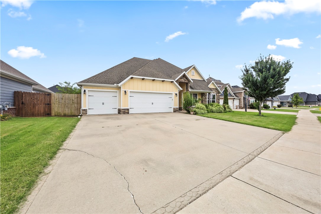 Charming Craftsman-style home in Maple Estates! Ideally located near (Walkable to) Bentonville West High School & Gamble Elementary, and just 15 minutes from Walmart HQ and XNA. This spacious home features an open-concept layout, vaulted ceilings with stained beams, granite countertops, wood floors, and soft-close cabinetry. The split floor plan includes a private guest/in-law suite. Enjoy the oversized lot, covered patio with stone fireplace, custom privacy shades, and professional landscaping. Neighborhood offers a luxury clubhouse, pool, and parks. All major appliances convey