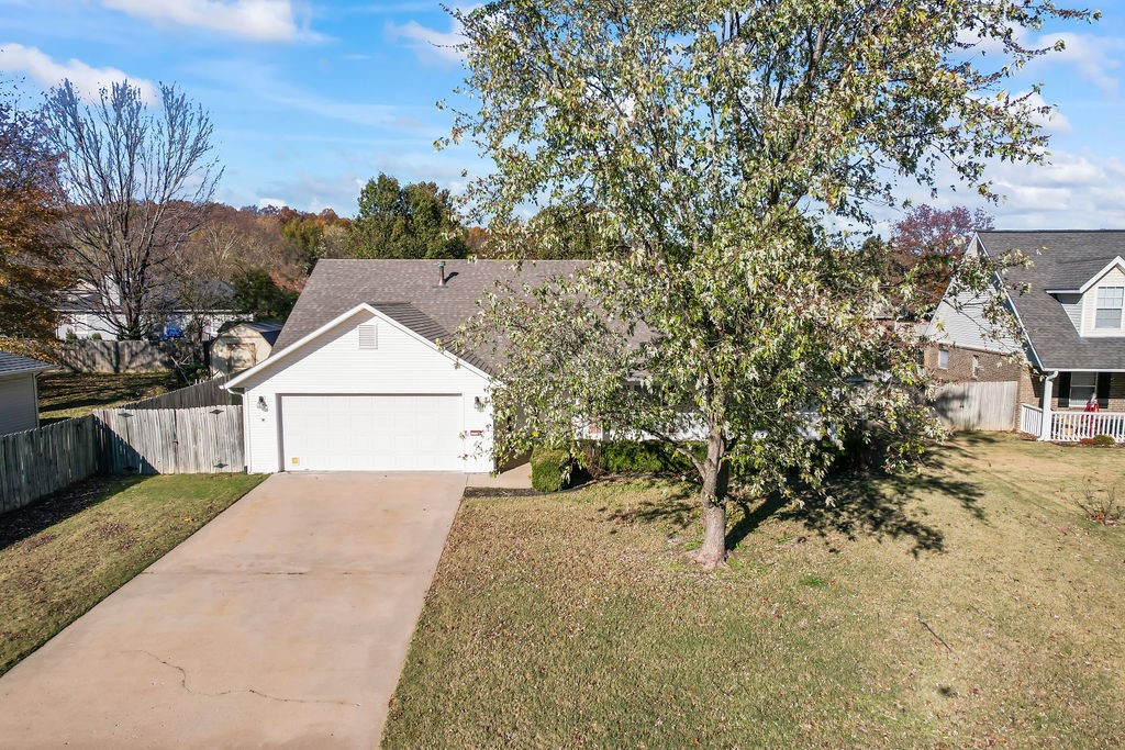Spacious 3-bedroom home in excellent condition, close to Holcomb Elementary, walking trails, and parks. Enter a large living room featuring a 2-sided gas fireplace and high ceilings. The primary suite offers two walk-in closets, and a separate soaking tub. Enjoy a formal dining area and breakfast area, pantry, and a dedicated laundry room. Step outside to a landscaped backyard with a rainwater drainage system and a sturdy overhang for year-round use. The welcoming covered front porch, window shutters, and mature trees add to the charm. You'll love the newer LVP flooring throughout. This fantastic layout is a must-see! The furnace and air handler were replaced in 2023, and the water heater in 2020.