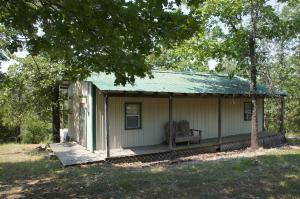 This one room cabin on approx. 4.93 wooded acres would be great for weekend get-away or hunting camp. Sit out on the rear deck (or front deck) and enjoy the natural beauty of the area and the critters too. Knotty pine finish inside. In need of some minor work. Seller will leave furnished, if requested. Call soon before it's gone!!!