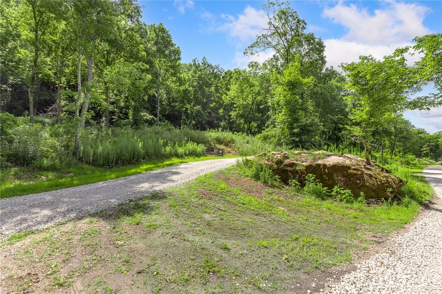 The groundwork is already done for you!  This lot comes fully equipped with underground utilities already in place, including natural gas, fiber optic internet, electric, public water, and sewer. No waiting, no guesswork, no costly setup—just a smooth, ready-to-build opportunity from day one!  Come check out Lot 120 (1.10 m/l ac) of Round Mountain Estates! It features large boulders, the bluffs of Round Mountain to the east and ownership on both sides of Significance Summit. This means you can clear (or not) some trees on the downhill side of your own property giving you views for miles! RME is the newest subdivision in Harrison, AR.  Beyond your homesite, you’ll have access to a 350 acre common area reserved for residents, featuring a stocked fishing pond, Kissing Rock Trail, natural springs, Baby Canyon Trail, striking bluff lines and views that stretch for miles.  *Terrapin Creek Rd will be paved in the future, per county officials.