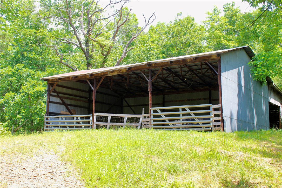 This 10+/- acre tract offers a blend of useful infrastructure, natural beauty, and expansion potential. The property has a water well, electric, propane line, and a possible septic system from a former homesite. A well house is in place, and internet is available, making this an ideal location for work or comfortable country living. Two large barns, one measuring approximately 44'x50' and the other 32'x50', provide ample space for storage, equipment, hay, or livestock. The acreage includes hardwood timber, rock bluffs, and a spring tucked into the hillside. These natural features offer incredible opportunities for hiking, hunting, or simply enjoying the environment. The terrain is varied yet accessible, with multiple potential build sites that offer privacy and views of the surrounding countryside. Located just 2 +/- miles off a paved Highway 23 and near a local swimming hole on War Eagle Creek. It's about 22 minutes to Huntsville, Arkansas, for supplies and conveniences, and just an hourās drive to Fayetteville