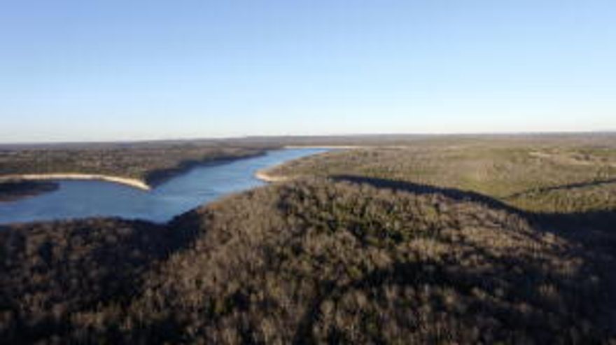 212.94 Acres M/L with more than 1/2 mile Bull Shoals Lake Corps frontage!! The property has about 35 acres of pasture and the rest is in woods.  Also is has an expansive lake view, seasonal waterfalls, springs, and creeks, and excellent hunting on established food plots. Additionally, 4 wheeler trails, electric on site, 1/2 a mile of paved road frontage, old homesteader's cabin and rock fences. This property has exciting potential for a lakeside development or estate homes. 3 miles from Tucker Hollow Marina and only 30 minutes to Branson!