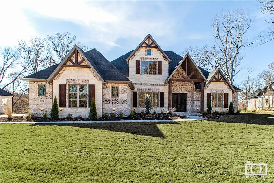 Contemporary elegance & thoughtful design in Copper Ridge; new construction by Capstone Design Build. This stunning estate is nestled on a large 1.05 acre lot with gorgeous wooded views. Sizable study just off the entry features built-in shelving & storage; French door entry. Formal dining boasts wainscoting, natural light & stylish fixture. Pass the custom staircase to find a cozy stacked stone fireplace flanked by built-ins, coffered ceiling with dark inlay, and large picture window. The Chef's kitchen displays a gas cook-top with pot filler, stainless appliances, custom cabinetry & island topped with granite, dual sinks, double oven, and walk-in pantry. Large buffet with additional storage in the breakfast nook; outdoor access. Master bedroom is simply stunning; tray ceiling with shiplap inlay, streaming natural light, and outdoor access. Relax in the spa-like master bath; luxurious garden tub, dual vanities with makeup area & giant walk-in closet. Conveniently located near I-49 & 8th street exit!!