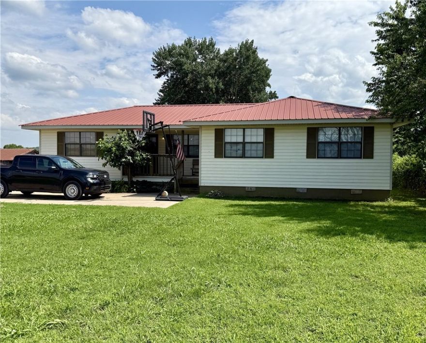 Wow, this place is great! If you are looking for a home and acreage out of town, this is it. 2.72 acres with 150x34 barn with fenced area for cattle, horses, etc. Nice 1,308 SF, 3 BR, 2 BA home, metal roof, newer A/C unit. Shop with electric & lots of covered porch spaces. All this and a working well to water the garden or livestock. Don't miss this one!