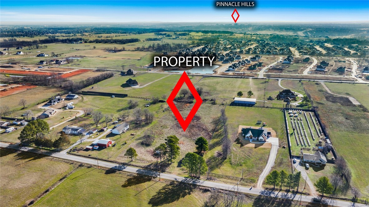 An extraordinary opportunity to own a one-of-a-kind land in a prime, highly sought-after location in Bentonville! This stunning 4-acre parcel, is surrounded by elegant estate homes sprawling on picturesque plains. Being just 5 minutes from Regional Airport Blvd, this land offers limitless possibilities for those seeking to build an exceptional residence. Positioned less than 15 minutes from XNA and under 20 minutes from the vibrant heart of Downtown Bentonville, this rare gem provides both convenience and exclusivity. This remarkable acreage is the perfect canvas for a luxurious estate, offering space, privacy, and unparalleled potential while being nestled within the top-rated Bentonville School District. Moreover, this is a unique opportunity for someone with vision for a small subdivision to bring in their creativity with future plans. Secure this prestigious property today and bring your dream to life! Land like this doesn’t come into market often.