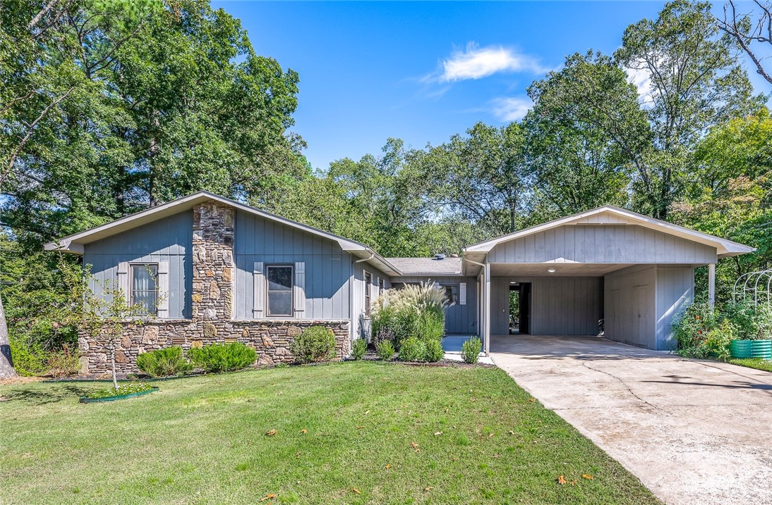 Welcome to your next home! Just under half an acre with a park-like setting and FLAT backyard. The patio is perfect for entertaining and watching the birds! Inside features 3 bedrooms, 2 bathrooms with a open concept living area and kitchen, ventless gas fireplace, light filled sunroom and wet bar perfect for your coffee or tea station. Enjoy the large workshop. The covered two car carport could easily be converted to a 2 car garage. Already connected to city sewer! Water heater- 2024, New roof to be installed at closing. The two garden beds do not convey. See attachments for more upgrades and information.