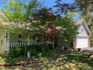 This lovingly maintained three bedroom, three bath home sits on a 3-acre lot and offers the feel of the country while also being in a neighborhood setting, and is a just a short drive (within 20 minutes) to both Harrison and Branson. Inside, the open floor plan house offers a wood fireplace, vaulted ceilings, two big storage rooms, a full/walkout basement, a two-car garage, and much more. Stepping outside, you'll find a large deck, a concrete patio and lots of towering pine trees. The roof, carpet on the main level, appliances, quartz counter tops, and metal fencing are all NEW within the last 3 years