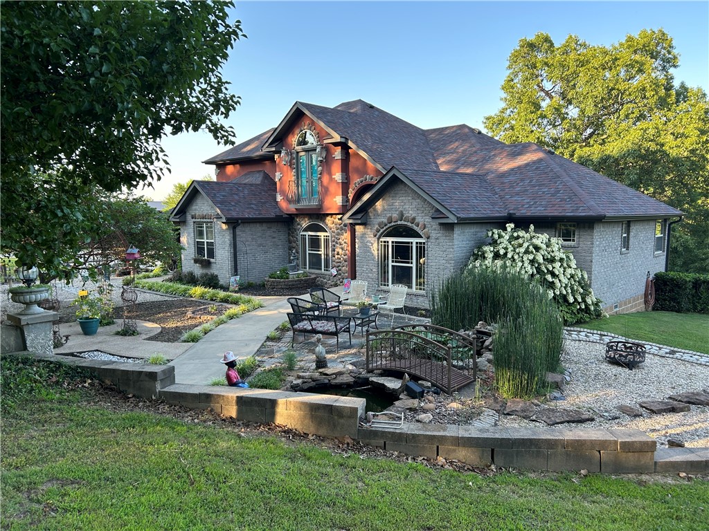 Beautiful 4acres with HWY72 frontage. House sits back of property for privacy. New roof, gutters w/shield, HVAC & refurbished decks 2024. Own your own estate w/amazing courtyard gazebo, flowers, large oak, dogwood, & redbud trees. Water flows from one pond to another stocked w/koi for enjoyment or relax on back deck w/your morning coffee.Quality construction, custom built w/wood & ceramic tiled floors in wet areas & carpet in bedrooms. Granite counters throughout. Cabinets galore, deep farm sink in kitchen & upgraded fixtures. The open living area is center of home w/stunning rock fireplace. Opens to eat in kitchen, formal dining room, coffee bar & office. Primary bedroom has outside access to back deck. Primary bath has corner whirlpool tub & large walk in shower w/separate his/her sinks. Upstairs is another living area w/bedroom & full bath. Property has a studio Apartment above 3 car garage/workshop included in sq ft. Great for home business/hobby farm. Plenty of parking for RV, boat 4 wheelers etc. Agent owned