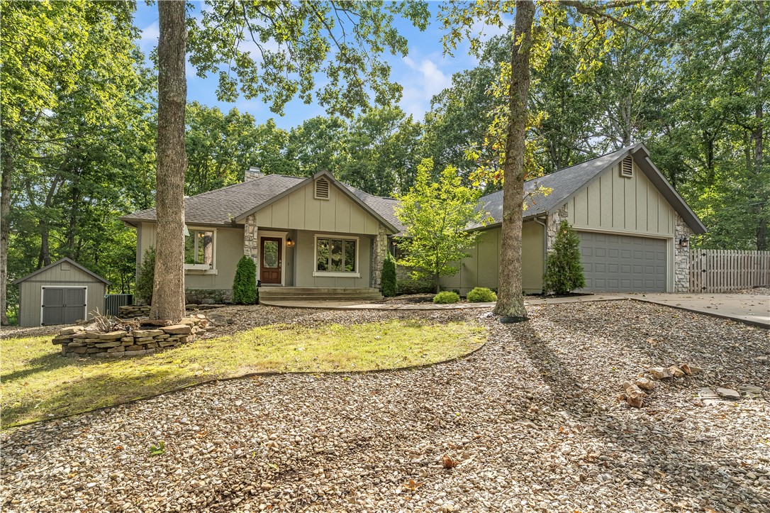 Nestled on a quiet cul-de-sac near Branchwood Rec Center and the Highlands area of Bella Vista, this beautiful home combines privacy with convenience. A welcoming living room with tall ceilings and a cozy fireplace sets the tone, while the sunroom boasts a wall of windows displaying wooded views and natural light. The kitchen is appointed with granite countertops, ample cabinetry, and stainless steel appliances. A versatile formal dining room can serve as a sitting area or home office, offering flexibility to suit your lifestyle. The spacious primary suite offers direct access to the back deck, along with an en-suite bathroom designed for relaxation. Fresh interior paint on the walls, ceilings, and trim make the home move in ready. Outdoor living is enhanced by a large deck overlooking the wooded backyard, and a well-maintained storage shed provides additional space. With its low-maintenance yard and thoughtful design, this wonderful home is ready to welcome its next owners.