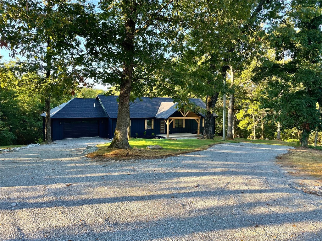 East Fayetteville New Construction! 1.39 Ac & in sought after Vandergriff School District! Fantastic layout, featuring bright & open living space, 3 bedrooms plus office, large laundry/mudroom. Circular drive & stunning wood beamed front porch w/landscaping. Living space w/vaulted ceilings, LVP flooring throughout & large windows bathing space in natural light. Living room w/gas fireplace & wood mantle. Spacious kitchen has large island w/counter seating, abundant workspace, pantry, custom hood vent, open shelving & granite tops. Dining off kitchen. 2 guest rooms share jack/jill bath w/extra deep combo tub. Office is great multi-use space. Primary suite w/windows to wooded views, barn door to attached bath featuring separate vanities, huge walk-in shower w/dual fixtures & large WIC. Laundry room w/tons of storage. Large deck provides outdoor living space w/ views & privacy. Yard is ready for, garden, chicken coop, shop. No covenants enjoy your 1+ acres! Conveniently located 15 min to Downtown Fayetteville!