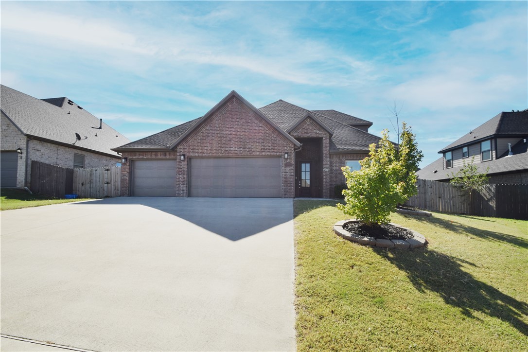 This Bentonville home offers a fantastic location with easy access to trails and community amenities. Bike trails to Osage & Creekside Parks are across the street, while the neighborhood features a pool and playground. A short drive to the Activity Center, and 15 mins to Walmart & I-49, it blends recreation and convenience. Located in the Bentonville school district, it sits on a corner lot with a privacy-fenced backyard and covered patio. Inside, 4 beds and 3 baths feature wood floors, tall beamed ceilings, and a fireplace. The open floor plan includes a kitchen with gas cooktop, granite counters, pantry, eat-at bar, and dining space. The primary suite has beamed ceilings, a walk-in closet, shower, tub, and double vanity. A 2nd bed and bath are on the main floor. Upstairs, two additional bedrooms, full bath, and a landing area perfect for a desk. Refrigerator, washer, and dryer included. Pet negotiable with owner approval. No smoking.