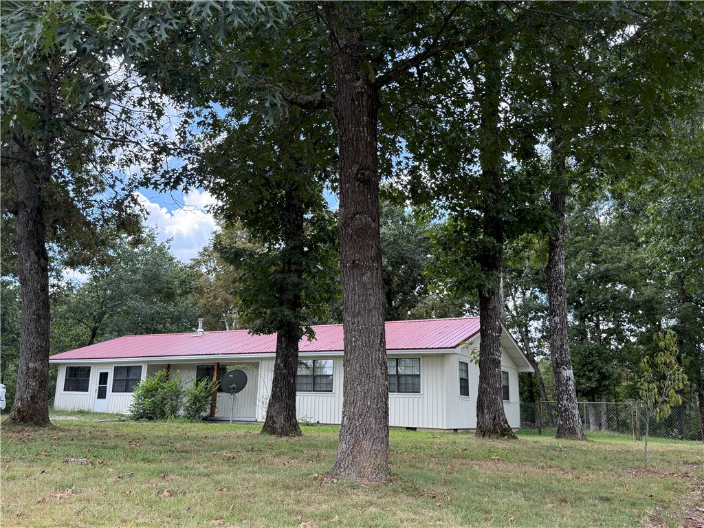 Enjoy the beautiful views of Withrow Springs State Park from your very own screened in porch! Sitting on one acre that borders beautiful Withrow Springs State Park, this 3 bedroom and 2 bath home has open living and an enormous yard with mature trees- plenty of room for stretching out or entertaining! Kitchen has granite countertops and includes refrigerator and appliances. A large laundry/mud room has a walk in pantry and access to the basement, the enclosed garage gives the option for a fourth bedroom, another family room or home office. Recently renovated with a 26 gauge metal roof, vertical vinyl siding, carpet, paint, storm doors and more!