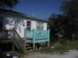 Easy, easy access off of Hwy 7 just south of Jasper, Ar. on 1/2 acre lot. Newer central air and heat units. Propane backup. 4 bedrooms and one bath with a spot for a 2nd bath in partially finished walkout basement (2 doors). New decks and much remodeling already done. Metal roof. Old cistern out back. Furniture will convey. This house is bigger than it looks from outside.
