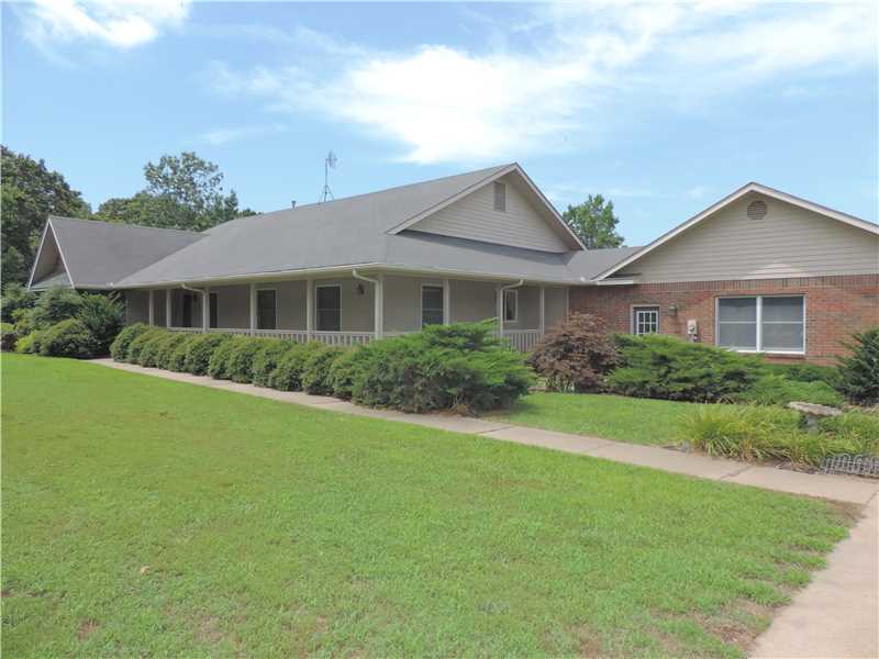 Beautiful ranch style home on 3.45 Acr only 10 Miles from Bentonville on a paved road.Includes a 2880 sq ft heated/cooled glass enclosed pool house, w/inground pool,hot tub,game room,wet bar,and workout room.,Back of the houseinvites you to sit on its wrap around porch w/ceiling fans. The concrete drive leads to detached 3 car garage.Pool house was build in 2001 and has a 1/2 bath. The house has cedar lined closets.