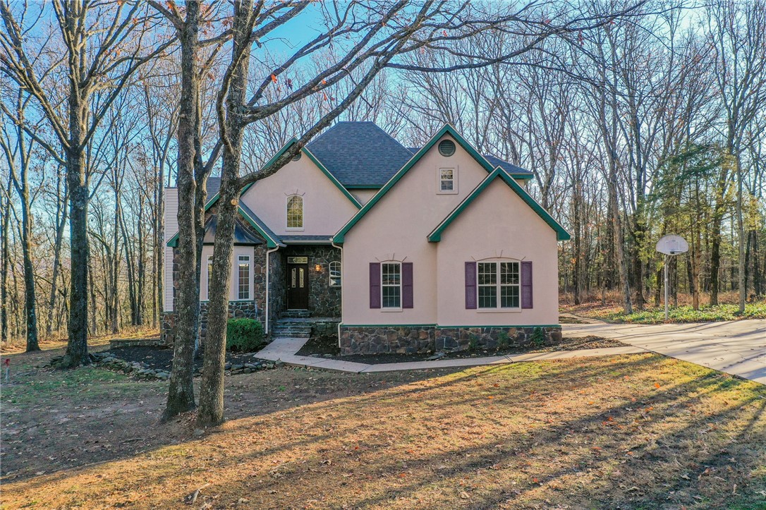 Looking for Peace and Quiet? This gorgeous 3 bedroom 2.5 bath home sits in the middle of 55 wooded acres. Home was custom built by Sellers. Large Primary Suite is downstairs and has a luxurious soaker tub. Recent upgrades include complete kitchen remodel in 2018. Both HVAC systems have been replaced in last 5 years. Roof was replaced 6 years ago. Ozarks Go available. The acreage is mostly wooded. A large metal shop building sits in a cleared area that feels like having your own private park. Come explore the rustic cabin and look for the hidden pond. Don't miss this opportunity.