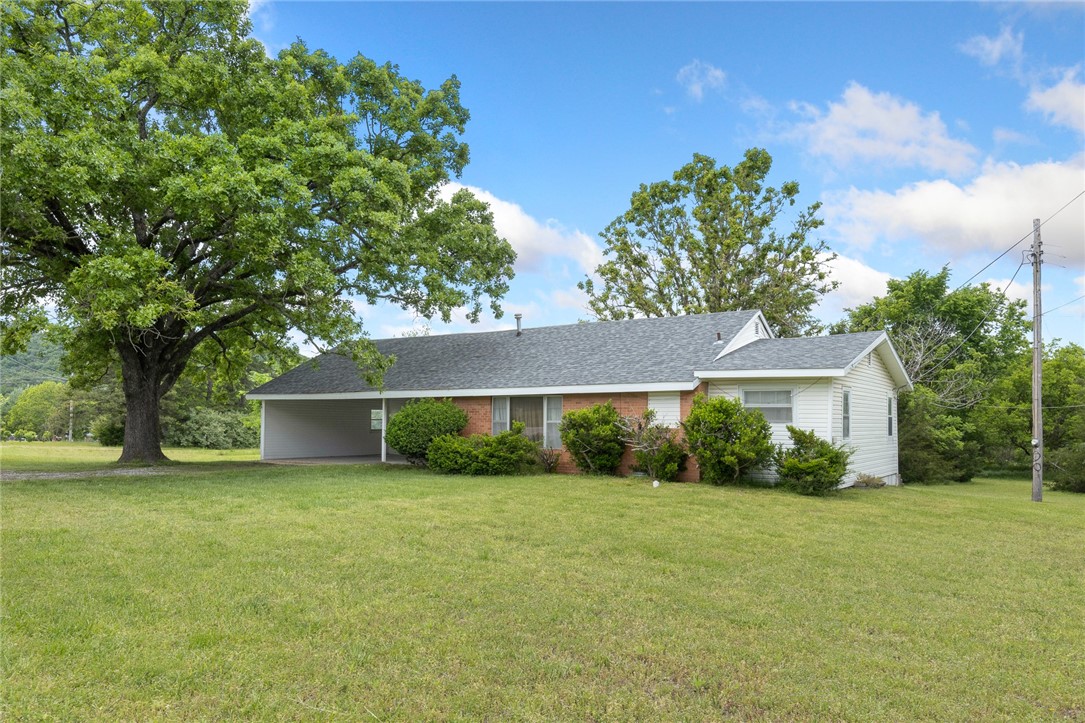 This well-maintained home is close to town, but has that country feel. With 1316 square feet of living space, a large family room and open kitchen/dining area, it's ready for your family! The oversized mudroom/laundry room even has a shower for those wash-ups after mowing--- or even used as a dog wash station after a day of adventures! There is an outer building previously used as an office which has electricity and can provide storage, or become a she-shed or a workshop. The roof was updated in 2019, and the large gas stove (2015) is serviced by a 1000 gallon propane tank! There is a well on-site (small red building in backyard), but not used. Rural water is onsite. Survey has been completed. Call today for your showing appointment!