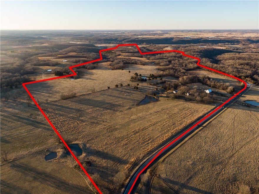 210 Acres +/- NW Arkansas w/One mile of Hwy 43 frontage running to top of Spavinaw hill.  A perfect mix of pasture and woodland! Currently running cattle. Hayfield, 3 pastures & pastured ridgetops, 8 ponds. Land lends to a place of privacy and splendor w/beautiful pine ridge point and sunset views as one of many spectacular building sites. Deep ravines, native timber, year-round spring draws wildlife and hiking adventures! Survey marker Cherokee Territory/Arkansas marks the state line of Okla and Ark. 25 acres lies in Oklahoma. Superb water well, Farmhouse is storage, Fleetwood doublewide, original oak haybarn, holding pens. Appx 20 minutes to XNA airport! See attached video. See MLS 1209128