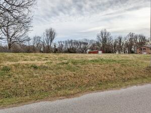 Great building spot on this near level 1.1 acres just outside of town on paved road with a 16 X 40 metal building. All utilities available. Land with no restrictions this close to town is hard to come by. Buyer to verify existence of utilities.