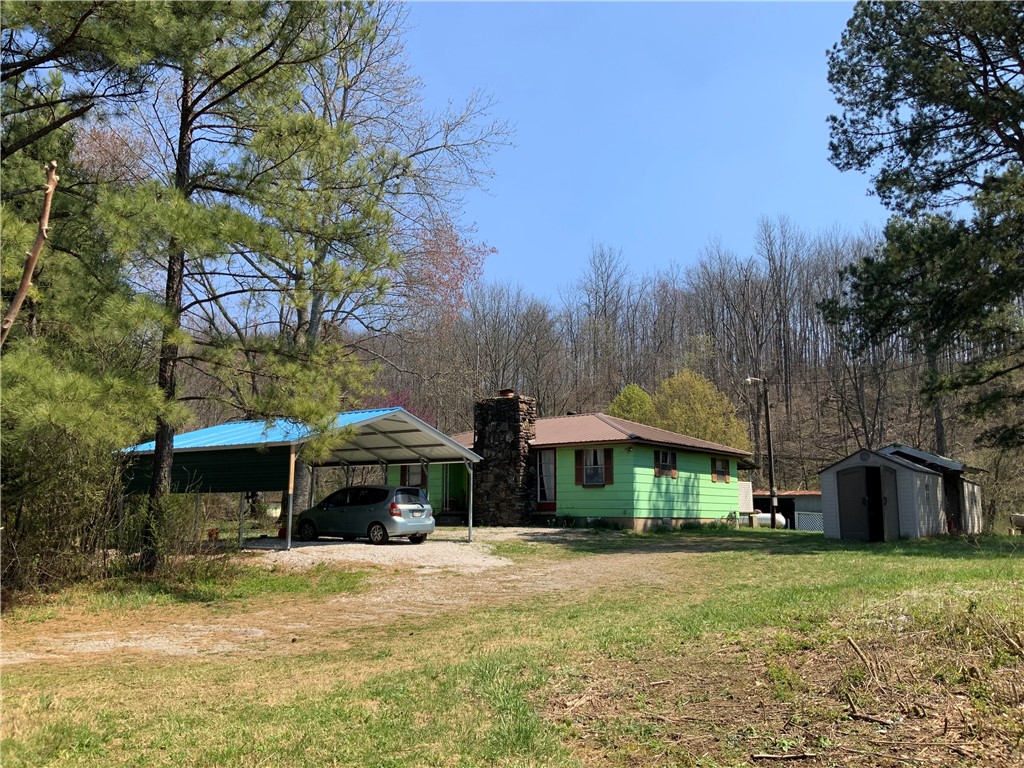 Well constructed older 3 bedroom 1 bath home on 1&1/2 usable, mostly open, acres. Well, rural water available, OzarksGo/electric for fast fiber optic, 2-8X40 and 1-8X20 shipping containers, numerous outbuildings. Highway frontage but the home sets off the road and quiet. Close to the White River, National Forest and miles of side by side/ ATV trails. Low maintenance masonite siding and a metal roof. Covered 8X16 back porch, large shade trees, surveyed. Less than an hour drive to Fayetteville/ Springdale area. 10 minutes to gas, shopping and eats. Affordable country living.