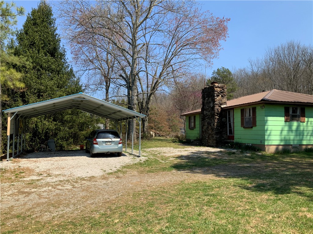 Well constructed older 3 bedroom 1 bath home on 1&1/2 usable, mostly open, acres. Well, rural water available, OzarksGo/electric for fast fiber optic, 2-8X40 and 1-8X20 shipping containers, numerous outbuildings. Highway frontage but the home sets off the road and quiet. Close to the White River, National Forest and miles of side by side/ ATV trails. Low maintenance masonite siding and a metal roof. Covered 8X16 back porch, large shade trees, surveyed. Less than an hour drive to Fayetteville/ Springdale area. 10 minutes to gas, shopping and eats. Affordable country living.