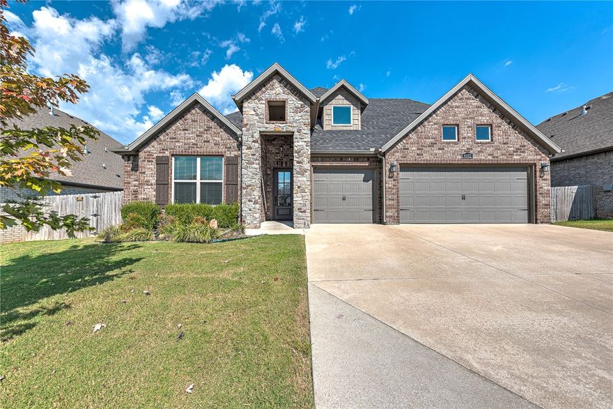 Impeccable modern residence near XNA Airport, top-rated schools, Walmart’s new Home Office, Hwy 112 & I-49. This move-in ready home features an open floor plan with towering ceilings and wood beam accents. The kitchen is designed for entertaining, with abundant counter space, stainless steel appliances, and a large walk-in pantry. The main level offers a guest bedroom or office with a full bath. The primary suite includes patio access, and a spa-like bath with soaking tub, walk-in shower, dual vanities & large closet. Upstairs features two bedrooms with a shared bath, bonus room & reading nook. Enjoy the covered patio with fireplace & TV hookup—perfect for entertaining. Additional highlights include a 3-car garage and a spacious laundry room with extra cabinetry.