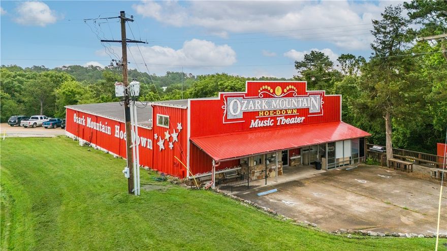 Owner Financing Options available.
Searching for a theater space for your variety show?  Here’s your chance to purchase 2.64 acres and a nearly 595 seating capacity theater with ticket booth, sound/light booth, concession stand an onsite apartment and 4 dressing rooms and 3 bathrooms back stage. The property offers two cabins in the wooded area, a large parking area dedicated to the theater and an outbuilding.  Building offers a separate retail space for souvenirs.