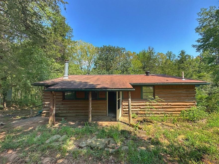 Diamond in the rough! Custom built log cabin with a shop on 4.25 acres m/l. Cabin has been gutted inside and is in need of total repair. A feeder creek runs though the lower part of the property and into the Illinois bayou. There is a bayou entrance right down past the property.