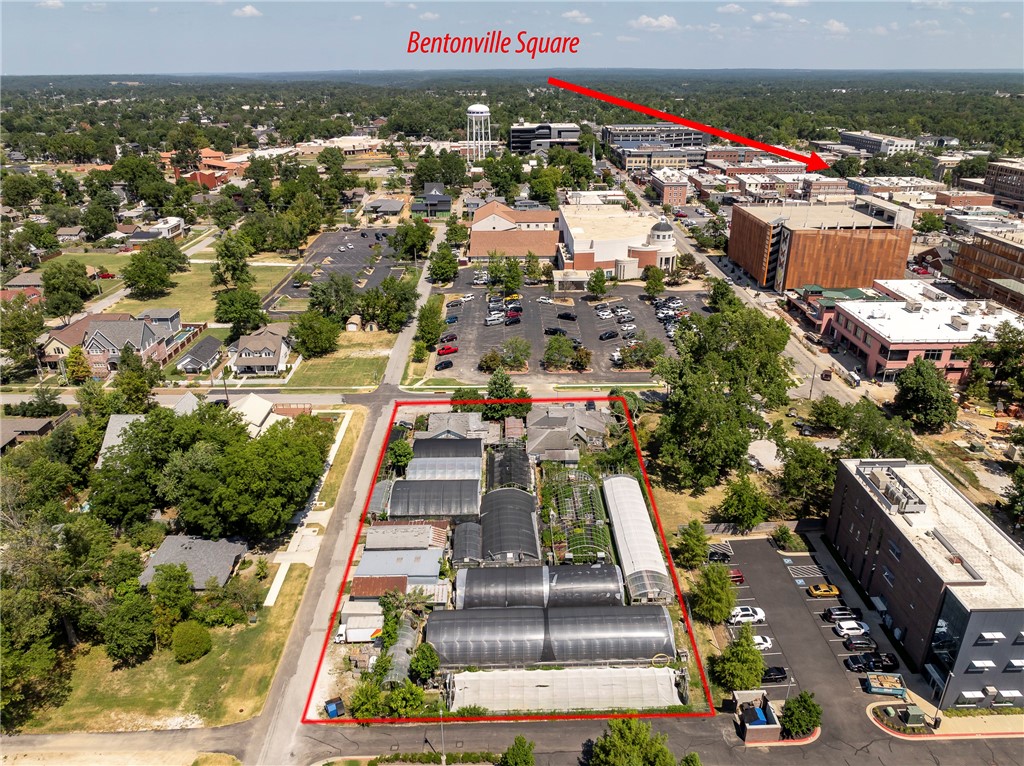 Exceptional opportunity to own a premier corner lot in the heart of Downtown Bentonville. Perfectly positioned near Skylight Cinema, the Ledger Building, and the vibrant dining and entertainment scene, this property is also just minutes from world-class mountain biking trails. With 123 feet of frontage along SW 3rd Street and 287 feet of frontage along SW B Street, it offers outstanding visibility and accessibility in one of the most dynamic markets in Northwest Arkansas. Currently operated as a flower shop and greenhouse, the true value lies in the land and the limitless possibilities for redevelopment. Just 1.5 miles from the new Walmart Home Office, this property combines a prime location with incredible potential for future growth and investment. Existing Greenhouse, and Flower shop business are NOT part of sale.