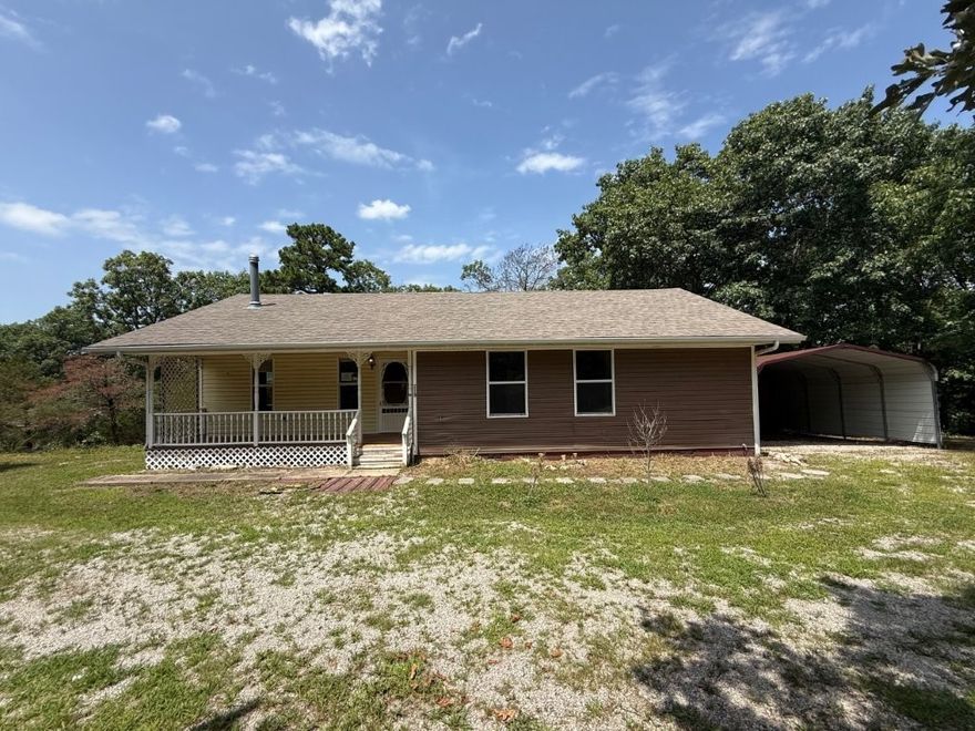 This secluded property offers the sanctuary of a wooded hillside yet close to town amenities. The house sits on a level overlook at the top of the hill with level area for gardening along the stone path walkway. Open floor plan, both bedrooms have private access to bathrooms. Ideal weekender, investment, or make this home your forever retreat!  Sold AS-IS, no repairs. Narrow and steep access to reach the property.