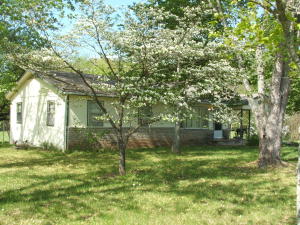 Nice 3 bedroom 1 bath home with highway frontage. Nice hardwood floors. Home comes with range, refrigerator, wall space heat and 2 window air units. One large unit and 1 small a/c unit in bedroom. Home has had CH&A in past.