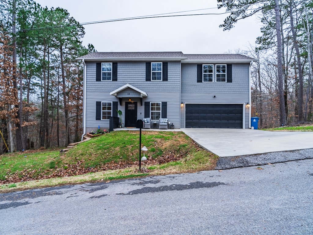NEW PRICE! Well maintained 2 story home near the Back 40 trails. 3 BR, 2 1/2 bath, 2 car garage features serene surroundings & mature trees, modern finishes thru-out w/ custom updates including shutters, half wall on porch, expanded front porch area, privacy panels to back deck as well as gate, handmade wood stairs, pine hand railing locally sourced from the lot, new ceiling fans & lights, new sink faucets in bathrooms & kitchen, added shelf & hanging storage in laundry room (will attach full list), hardwood floors, custom cabinetry, granite counter tops, lots of storage & large upstairs landing. Refrigerator, GE washer & dryer convey. Spacious backyard backs up to forest. Enjoy nature in this quiet area.