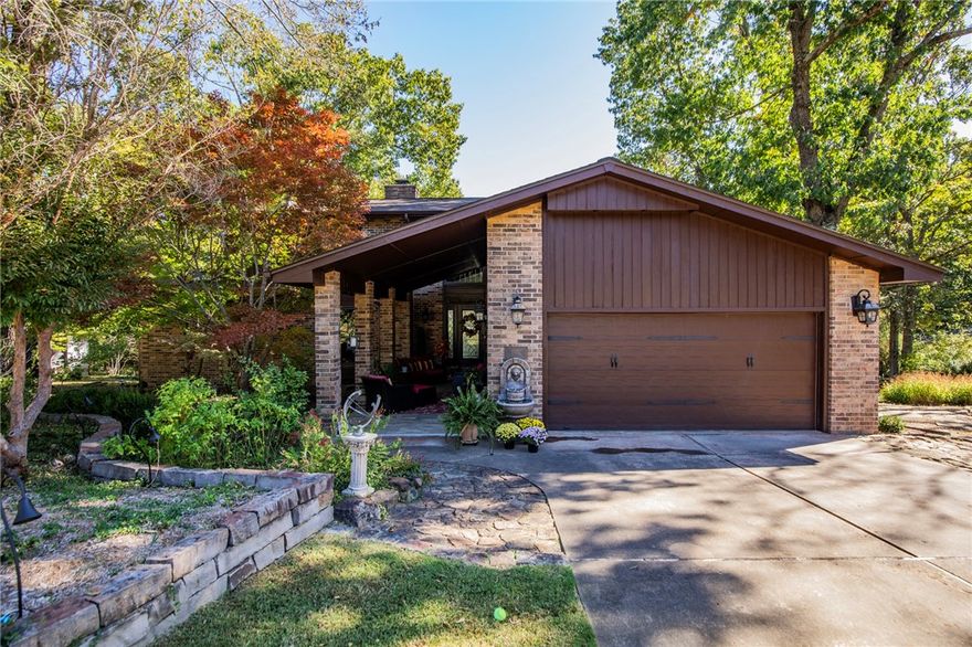 Stunning three-level home featuring 3 bedrooms and 3.5 baths, each with a private en suite. Bright, functional layout designed for comfortable living and entertaining.

The lower level offers a true entertainment area with a full bar and wine storage. Outdoor spaces include multiple patios, a welcoming front porch, iron fencing, lighted perennial gardens, and an outdoor fireplace.

Situated on almost an acre in a peaceful, park-like setting, this property offers privacy while remaining close to town and Beaver Lake. A rare combination of space, setting, and convenience just minutes from Downtown Rogers.