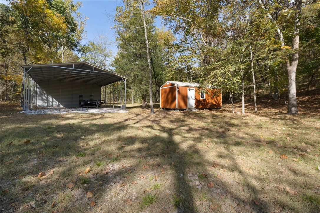 Forty Unrestricted Acres in Eureka Springs! Beaver Lake area. 30x35 Carport. 12x24 Shed. Beautifully landscaped and cleared for building. Wet weather creek flows along the edge of property. Culvert has been installed at the entrance. Exceptionally level coming into the property with plenty of areas to build! Surrounded by wooded views! Deer blind is towards the back of the clearing. At the highest point of the property, with winter views, you are able to see the lake! Minutes from a community boat dock, and about 15 minutes to Eureka Springs! So many possibilities!