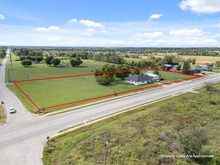 Outstanding Commercial Opportunity! 2.79 acres zoned C-2 Thoroughfare Commercial at the Northwest Corner of Old Wire Road (Highway 265) and East Apple Blossom Avenue in Lowell. Very busy corner and getting busier by the day with all of the new housing being built in the immediate area (Shuber Mitchell Homes owns 70+ acres directly across the street). This lot would be ideal for a gas station, shopping center or basically anything that relies on a high traffic count. Plenty of room to turn this property into an investment that pays off for generations. Property is also less than 3/4 of a mile from the scheduled I-49 to Hwy 265 Springdale Bypass. The house on the property is well kept and currently occupied by renters. Please do not disturb the inhabitants of the house.