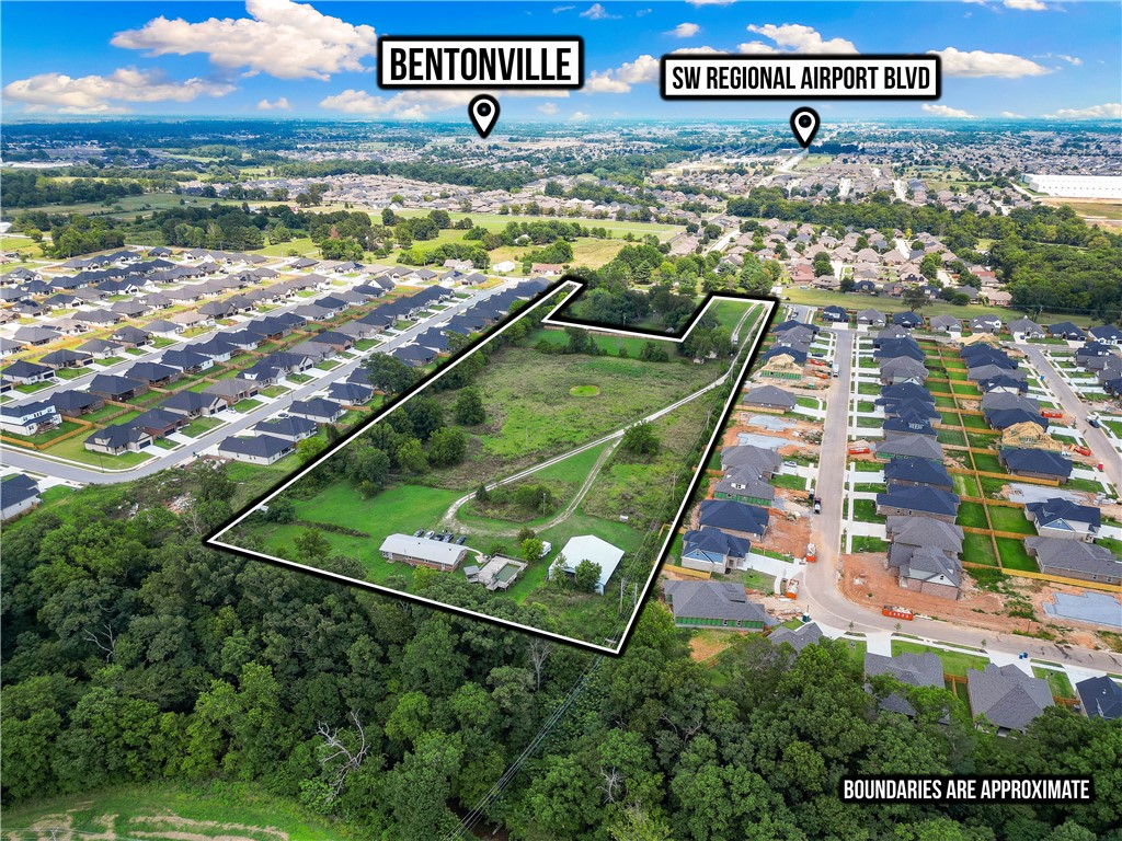 Seize one of the last large tracts in Bentonville’s high-growth corridor. This 10-acre property offers outstanding development potential with zoning and approvals already in progress. Featuring two income-producing residences, a covered barn, and full utility connections, the site is fully functional while you finalize your plans. Strategically located just minutes from Bentonville’s core amenities, this property is ideal for residential, mixed-use, or other creative projects. Whether you’re ready to break ground now or secure a valuable parcel for future appreciation, opportunities like this are increasingly rare in the market.