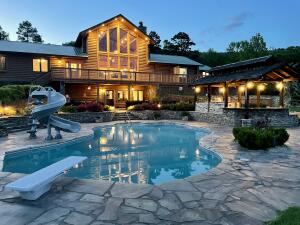 This Log Home Oasis sits on 43.59 ac m/l, Borders national forest, perfect setting, pond w/tackle shed, 40x60 shop w/heat & air & bath. RV hookup. A detached pavilion w/bath & fireplace. A Smokehouse and bonus well. Inground saltwater pool (fiberoptic lighting) that is self cleaning/heating/cooling AND an outdoor kitchen at poolside. Generac Generator & house filtration system. A water fall that cascades to the pavilion reservoir & back to the waterfall. Outdoor sensor night lighting. Inside is an Immaculate Master suite, chef's kitchen w/butler's pantry. Numerous bonus rooms such as a loft, fitness room, game room, saferoom, office, bedroom w/sitting area and bonus apartment with bed/bath/kitchen. Fiberoptic Internet. This would make a PERFECT Corporate or Personal Retreat.