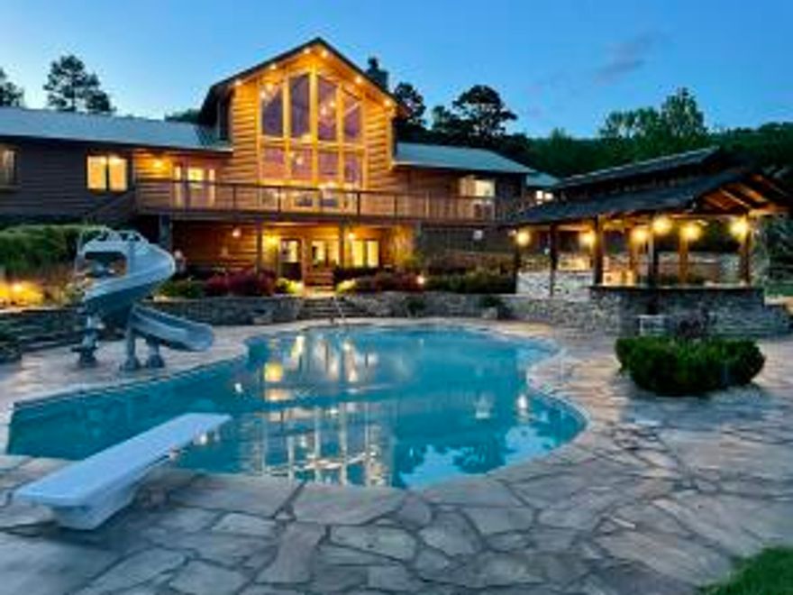 This Log Home Oasis sits on 43.59 ac m/l, Borders national forest, perfect setting,  pond w/tackle shed, 40x60  shop w/heat & air & bath. RV hookup. A detached pavilion w/bath & fireplace. A Smokehouse and bonus well. Inground saltwater pool (fiberoptic lighting) that is self cleaning/heating/cooling AND an outdoor kitchen at poolside. Generac Generator & house filtration system. A water fall that cascades to the pavilion reservoir & back to the waterfall. Outdoor sensor night lighting. Inside is an Immaculate Master suite, chef's kitchen w/butler's pantry. Numerous bonus rooms such as a loft, fitness room, game room, saferoom, office, bedroom w/sitting area and bonus apartment with bed/bath/kitchen. Fiberoptic Internet. This would make a PERFECT Corporate or Personal Retreat.