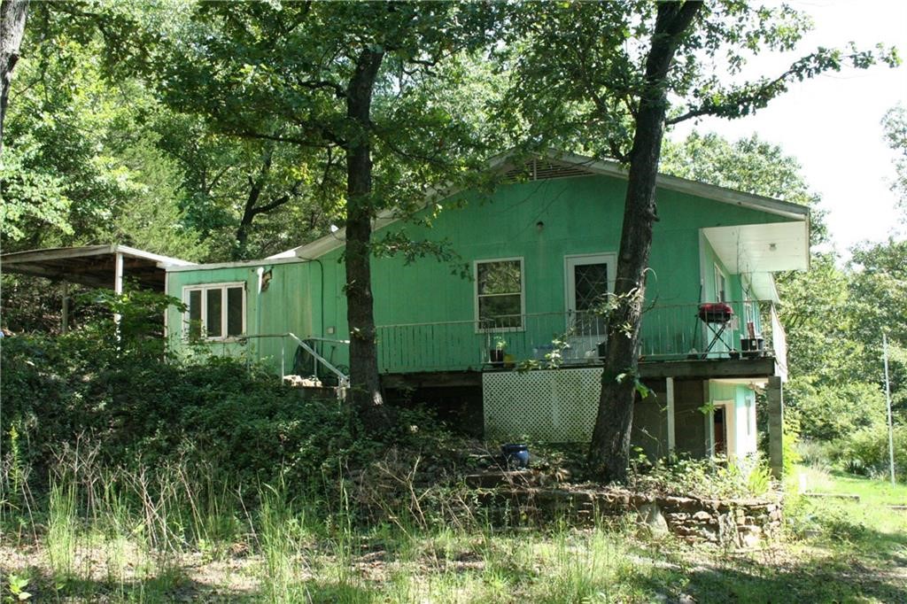 Great investment property! Priced to sell! Year-round CROOKED CREEK FRONTAGE with nice swimming hole. Two homes for the price of one on 4.43 acres. Main house has 1416 sq ft, 4 bdrms 1.5 bath. Guest house is a 2bd, 1 bath 840 sqft home looking over the creek. The houses need work. 1/2 open pasture and 1/2 wooded. End of road privacy. 2904 and 2920 Gooch Hollow Rd are being sold together. Second house is great for adult children, mother in law home, or as an Airbnb nightly rental. Only 1.9 miles on gravel. Seller states property is being sold AS-IS WHERE-IS. All numbers and dimensions are approx.