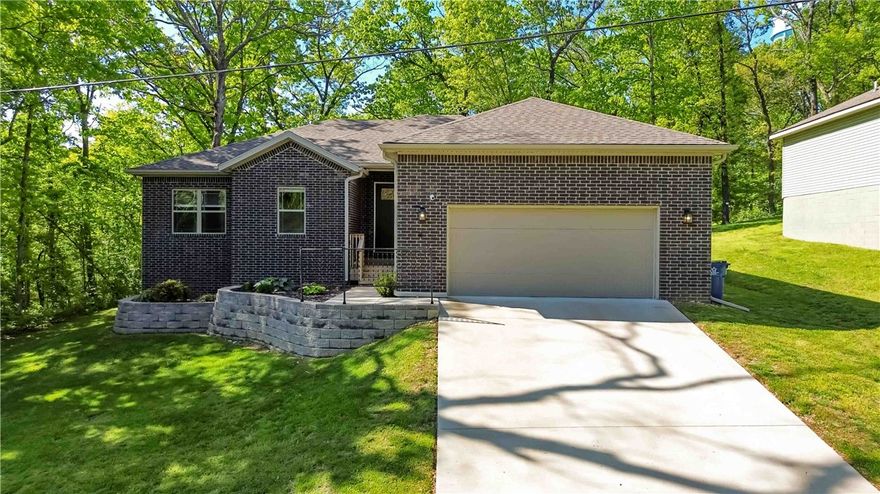 Welcome to the house on the hill, a stunning blend of modern elegance and cozy comfort in the heart of Bella Vista. This sanctuary offers a thoughtfully designed floor plan featuring 3 spacious bedrooms, 2 bathrooms, plus a dedicated office—perfect for the remote professional or creative soul. As you step inside, the 10-foot ceilings create an airy, expansive feel. Large windows invite a wash of natural light, highlighting the clean lines and high-end finishes that define the space. The primary suite includes a statement wall, private bath with a tiled shower and garden tub. Whether you’re hosting friends in the open-concept living area or enjoying a quiet morning in the sun-drenched kitchen, every corner feels intentional and inviting. Located just minutes from Bella Vista’s world-class trails and lakes, this home isn't just a place to live—it’s an invitation to a better lifestyle. From the moment you enter, you’ll know you’ve found something special. Come in, stay a while, and fall in love.