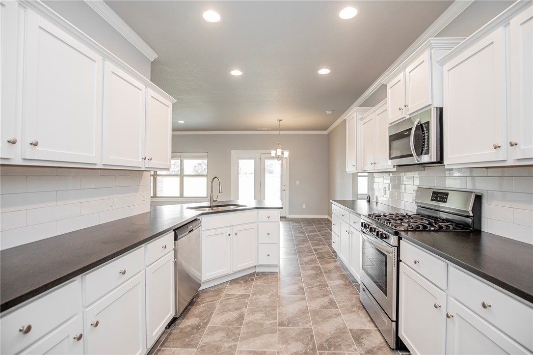 Welcome to your dream home! This house is situated in a peaceful neighborhood with close proximity to Beaver Lake. With 4 bedrooms and 3 bathrooms, this home offers plenty of space for your family and guests to feel comfortable and at home. The home includes motion sensor light switches which add a modern touch and make life just a bit easier. The beautiful kitchen is a chef's dream with granite countertops, lots of cabinets, and a spacious pantry. The open-concept living and dining area is perfect for entertaining guests or spending quality time with loved ones. After a long day, cozy up by the gas fireplace in the living room and enjoy the warmth and ambiance it provides. The 3-car garage offers plenty of storage and parking space, while the outdoor space is perfect for relaxing and enjoying the beautiful Arkansas weather. But perhaps the best feature of this home is its proximity to the lake. Schedule a showing today and see it for yourself! Floor plan in pictures is not exact.