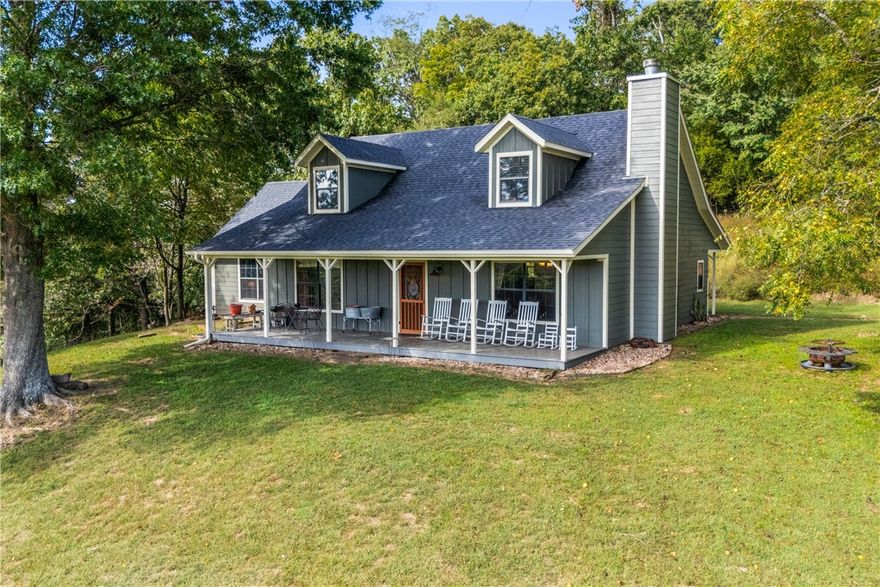 Unbelievable views, versatile land, and a beautiful home—All just minutes from Fayetteville!! Enjoy serene country charm with access to modern amenities like fiber internet and public water. There are currently livestock across the field along with other farm animals and it is fully fenced. There is a large pond at the heart of the property, a large industrial strength shop, multiple barns all located a few minutes from Hwy 71 & I-49. The 3-bedroom, 2.5-bath home features a flexible floor plan, including a main-level bonus room/office/4th bedroom or second living area. The main level also has a recently updated kitchen, pantry, mudroom, cozy wood burning fireplace, and an efficient wood stove on the opposite end. Upstairs has 2 beds, full bath, large storage room. Updates include but not limited to brand-new Hardie board siding exterior, 3-year-old HVAC, 4-year-old roof, updated kitchen with newer appliances. This is the private but close-to-town opportunity you have been waiting for! Come see it asap!