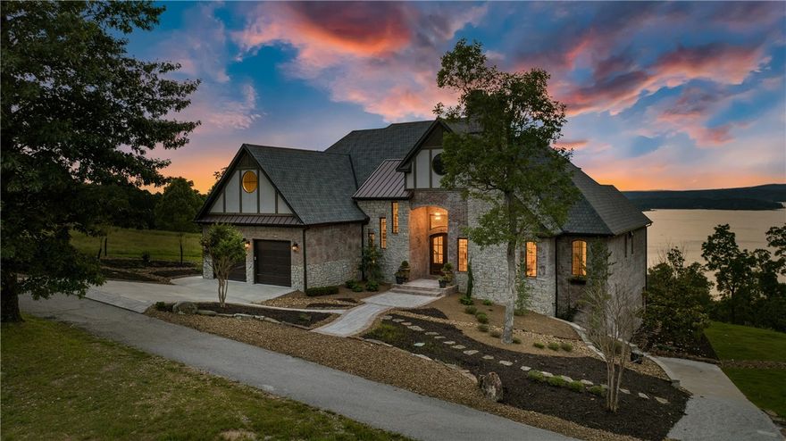 Situated on a coveted lot, this exquisite custom built home is perfection with fresh and modern finishes.  Thoughtfully designed with entertainment in mind this residence boasts both formal and casual living spaces featuring floor-to-ceiling windows and sun-filled rooms of panoramic lake views. Inside you’ll find updated on-point designer fixtures and finishes, wide plank hardwood flooring, coffered ceilings, new sisal carpeting, designer wallcoverings and new airy paint palette. This peaceful escape offers 6 bedrooms, 4 full baths, 1 half bath, 2 living areas, dining room & full walk-out basement w/new bar. The gourmet kitchen is the crème-de-la-crème of style and function, offering Viking appliances, custom pantry, spacious island and eat in dinette overlooking the water. From the carefully manicured grounds to the spectacular Beaver Lake views, this home is truly picturesque. This property offers community clubhouse, pool, community boat dock with slip & lift and is conveniently located near Rocky Branch Marina.