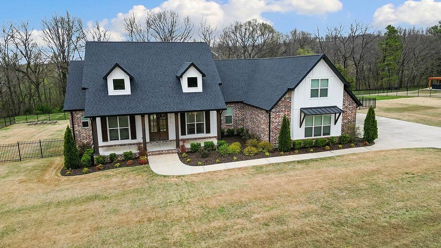 Nestled in the coveted Riverside Estates, this stunning 5-bedroom, 3.5-bathroom home sits on 2.02 acres, offering luxurious country living just minutes from town—Mission Rd (15 min), Tyson Headquarters (25 min), Fayetteville Square (22 min) & Sassafras Winery (12 min). The open-concept design features high ceilings, abundant natural light, & a spacious layout ideal for entertaining. The gourmet kitchen is equipped with top-tier appliances, custom cabinetry, large island with seating & a walk-in pantry. The adjacent dining & living areas provide ample space for gatherings. The primary suite boasts tray ceilings, a feature wall, and a spa-like bathroom with a soaker tub and fully tiled shower. Upstairs, a large 5th bedroom/bonus room with an en-suite bathroom offers versatility. Additional highlights include wood floors, a 3-car garage, a mudroom, and a raised garden bed area. Enjoy the large, covered patio, pergola, and access to the White River from the neighborhood; perfect for kayaks or canoeing with the family!