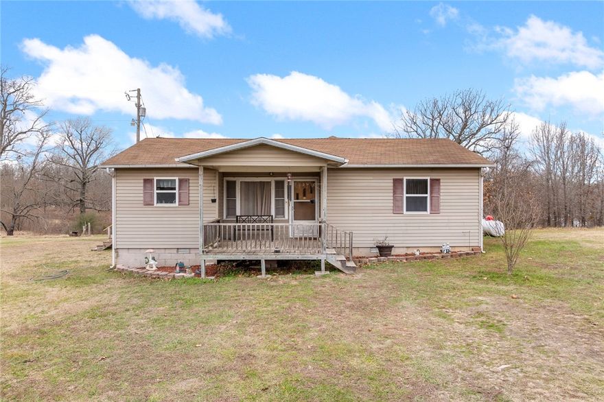 Peaceful country living with a convenient location! This 3 bedroom, 2 bath home sits on 1.56 acres in the Bergman School District, perfectly positioned between Harrison and Bergman with only a short stretch of gravel road. School bus pickup is right in front of the house. Inside, you’ll find a spacious primary suite with a walk-in closet, semi-open floorplan, along with comfortable living spaces throughout. The home is heated by a wood stove and two wall-mounted propane heaters and cooled by two window air conditioning units. Outdoor features include porches and covered deck space to enjoy the quiet setting. A great opportunity for buyers looking for space, privacy, and a convenient rural location.