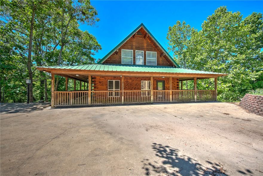 Lakefront retreat on Beaver Lake just 15 minutes from Downtown Rogers dining and entertainment. This distinctive 3 level cabin offers elevated lake living with vaulted ceilings, open-concept design, and expansive wraparound decks on multiple levels for seamless indoor-outdoor living. The upper-level primary suite is a private escape with serene lake views. The lower level features two additional bedrooms, a second living area with wood burning stove, and a bonus room with gun safe ideal for guests or flexible use. A private walking trail leads directly to a 2 slip dock and the clear waters of Beaver Lake, providing rare true lakefront access. Designed for both relaxing and entertaining, this property delivers the ultimate lake lifestyle with space, privacy, and unbeatable proximity to Rogers.